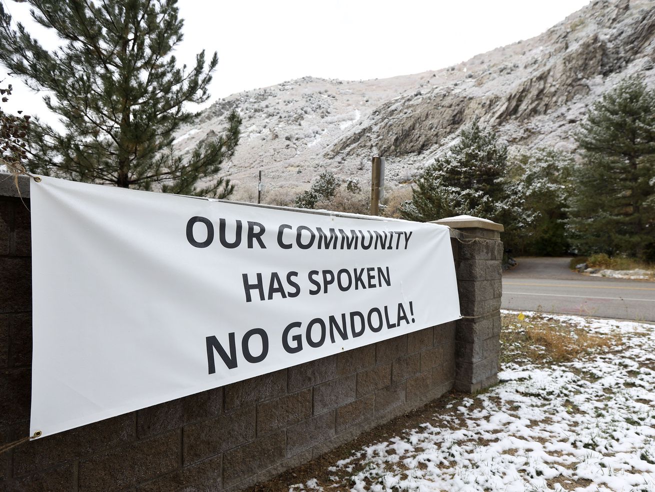 A banner hangs in opposition to the proposed Little
Cottonwood Canyon gondola near the base of the canyon in Cottonwood
Heights on Oct. 14.