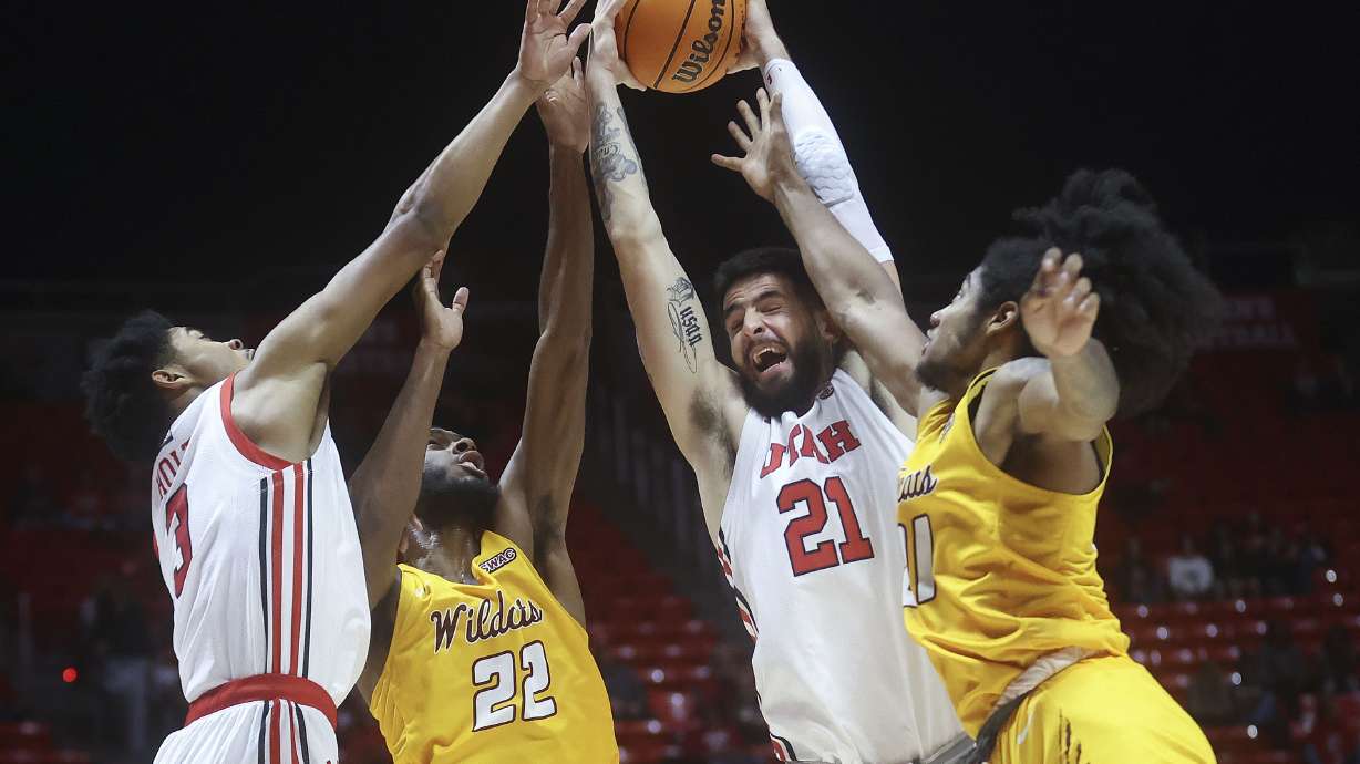 Utah Utes forward Bostyn Holt (3), Bethune-Cookman Wildcats center Dylan Robertson (22), Utah Utes forward Dusan Mahorcic (21) and Bethune-Cookman Wildcats forward Jonathan Bolden (21) reach for the rebound during a mens basketball game at the Huntsman Center in Salt Lake City on Monday, Nov. 15, 2021.