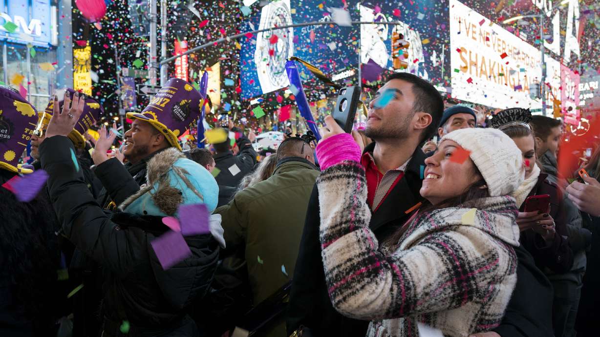Confetti falls as people celebrate the new year in New York's Times Square, Jan. 1, 2017. Crowds will once again fill New York's Times Square this New Year's Eve, with proof of COVID-19 vaccination required for revelers who want to watch the ball drop in person, Mayor Bill de Blasio announced Tuesday.