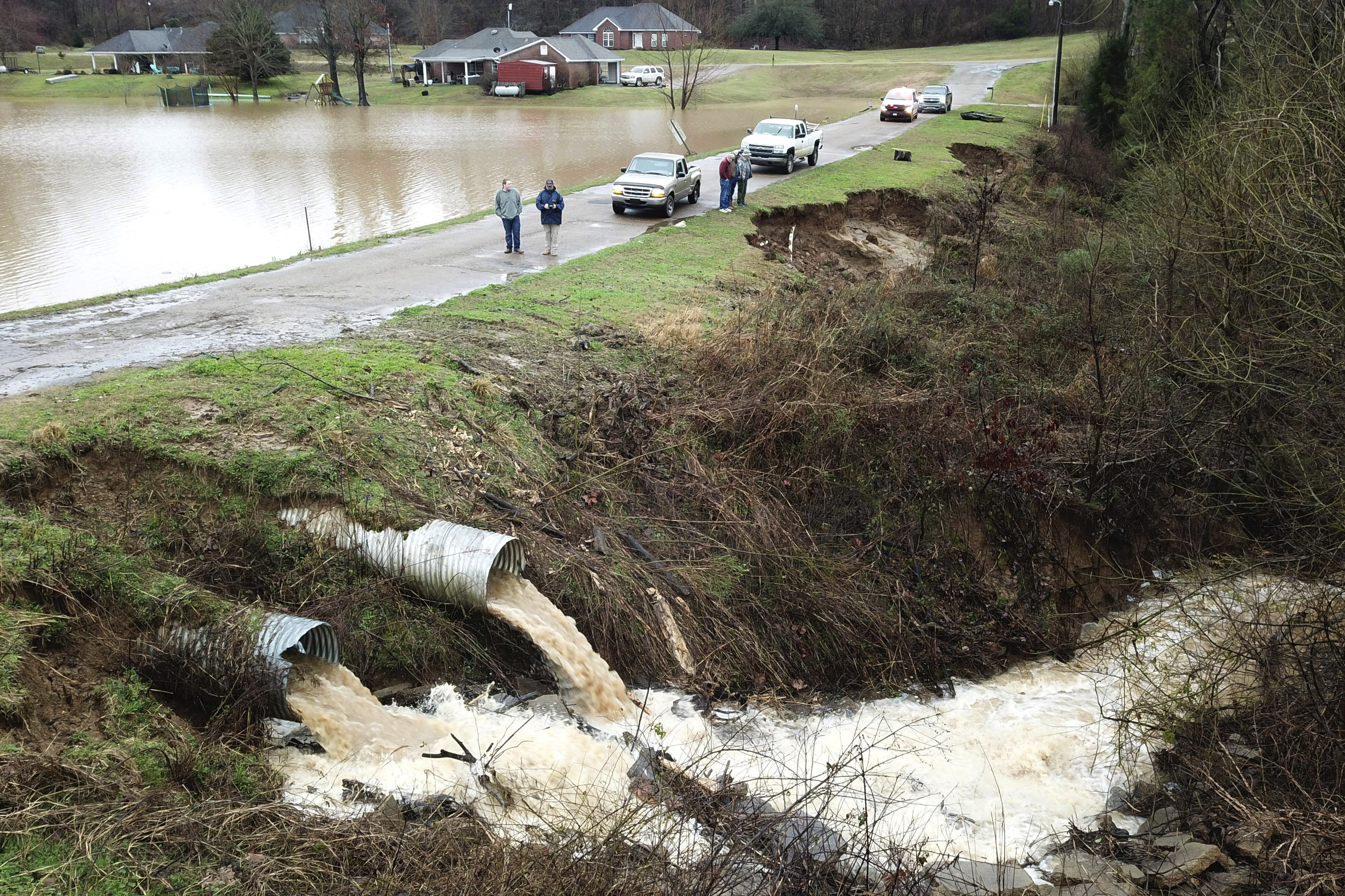 Area officials monitor a potential dam/levee failure in the Springridge Place subdivision in Yazoo County, Miss., on Feb. 11, 2020. Federal money is poised to flow to states to address a pent-up need to repair, improve or remove thousands of aging dams across the U.S., including some that could devastate downstream towns or neighborhoods.