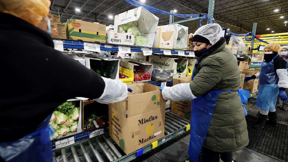 Workers fulfill orders at Misfits Market, a new
warehouse and distribution facility in West Jordan, on Nov.
15.