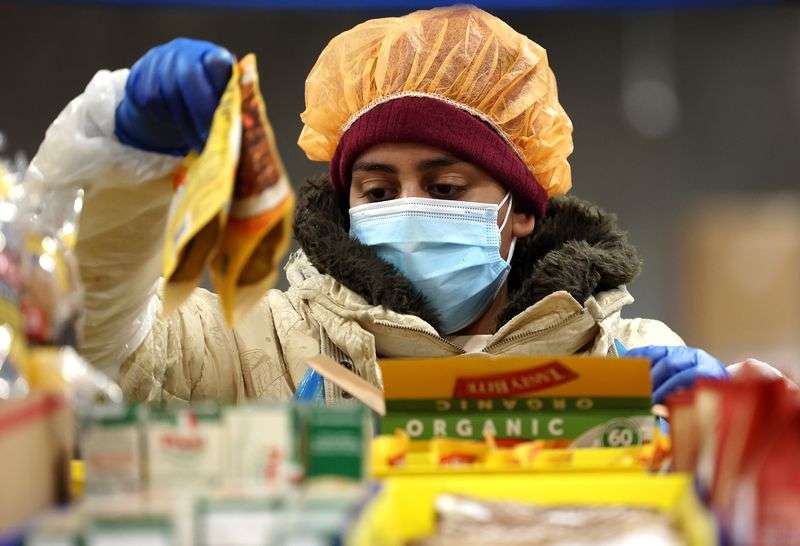 Workers fulfill orders at Misfits Market, a new
warehouse and distribution facility in West Jordan, on Nov.
15.
