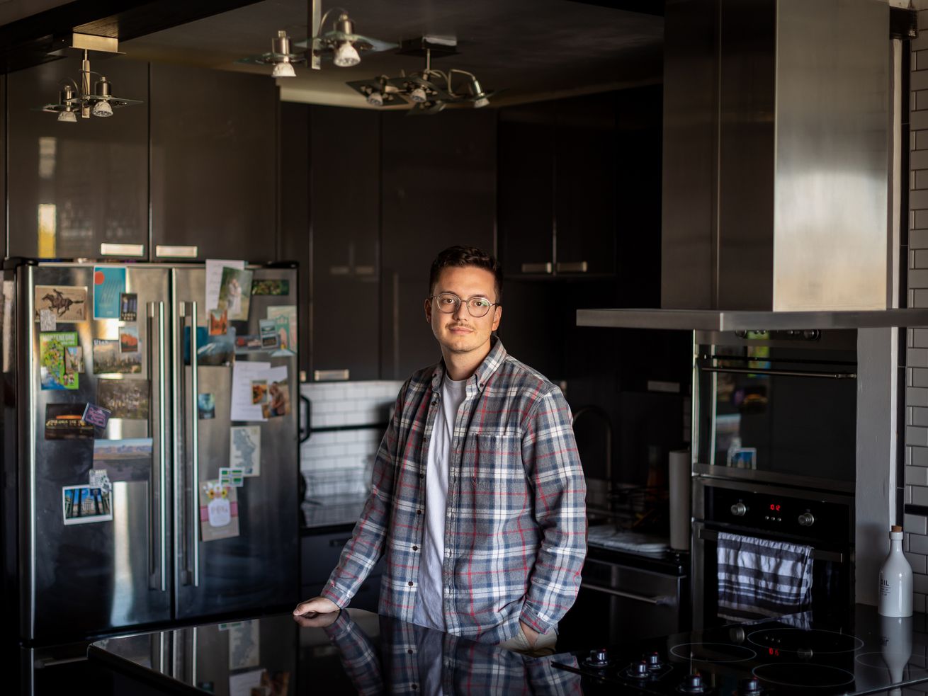 Leo Masic poses for a photo in his condo in Salt Lake
City on Oct. 22.