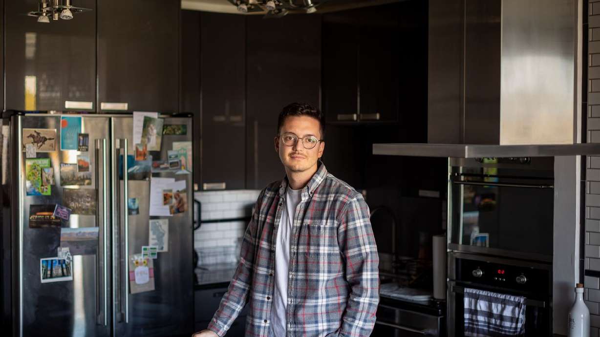 Leo Masic poses for a photo in his condo in Salt Lake
City on Oct. 22.