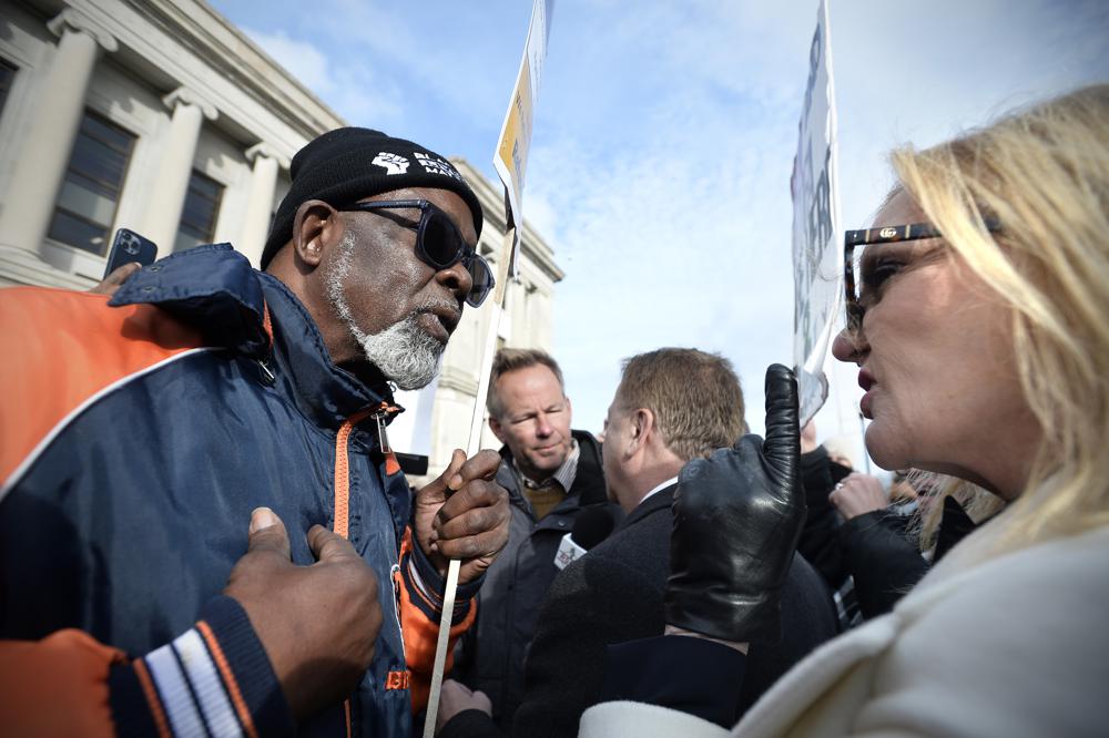 Clyde McLemore, founder of Black Lives Matter North Chicago Chapter, left, argues with Patricia McCloskey, right, as her husband, Mark, center, gives an interview in front of the Kenosha County Courthouse during Kyle Rittenhouse's trial in Kenosha, Wis., Tuesday. Rittenhouse is accused of killing two people and wounding a third during a protest over police brutality in Kenosha in 2020.