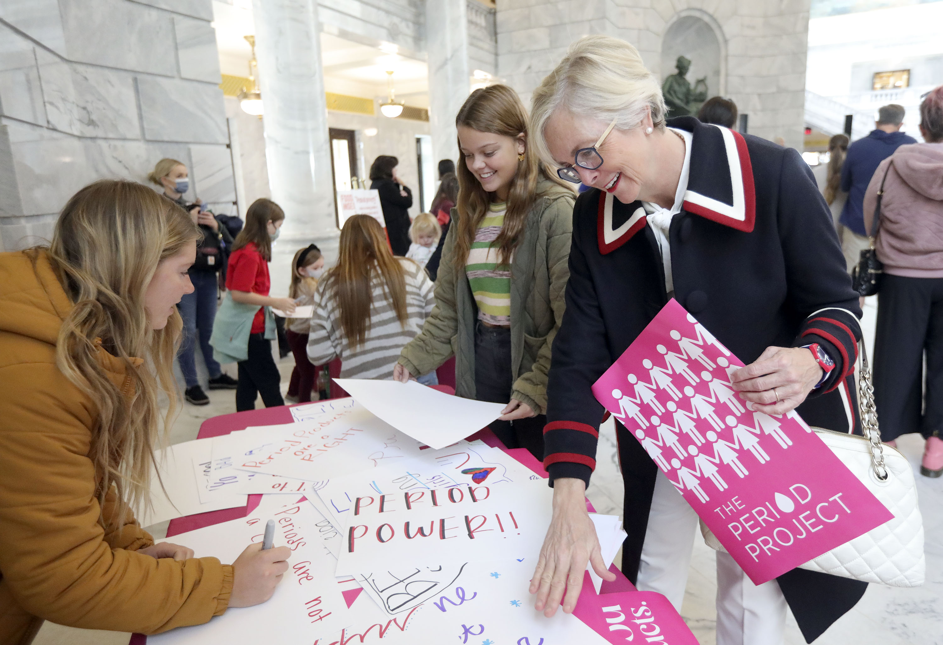 Former Rep. Becky Edwards, R-North Salt Lake, right, looks at signs as Anna Stewart, left, makes a sign at a Period Project rally at the Capitol in Salt Lake City on Wednesday. Those in attendance called on the Utah Legislature to offer free and safe period products in every public and charter school in Utah in an effort to rid the state of period poverty and allow greater access to education for girls and menstruators 18 and younger.