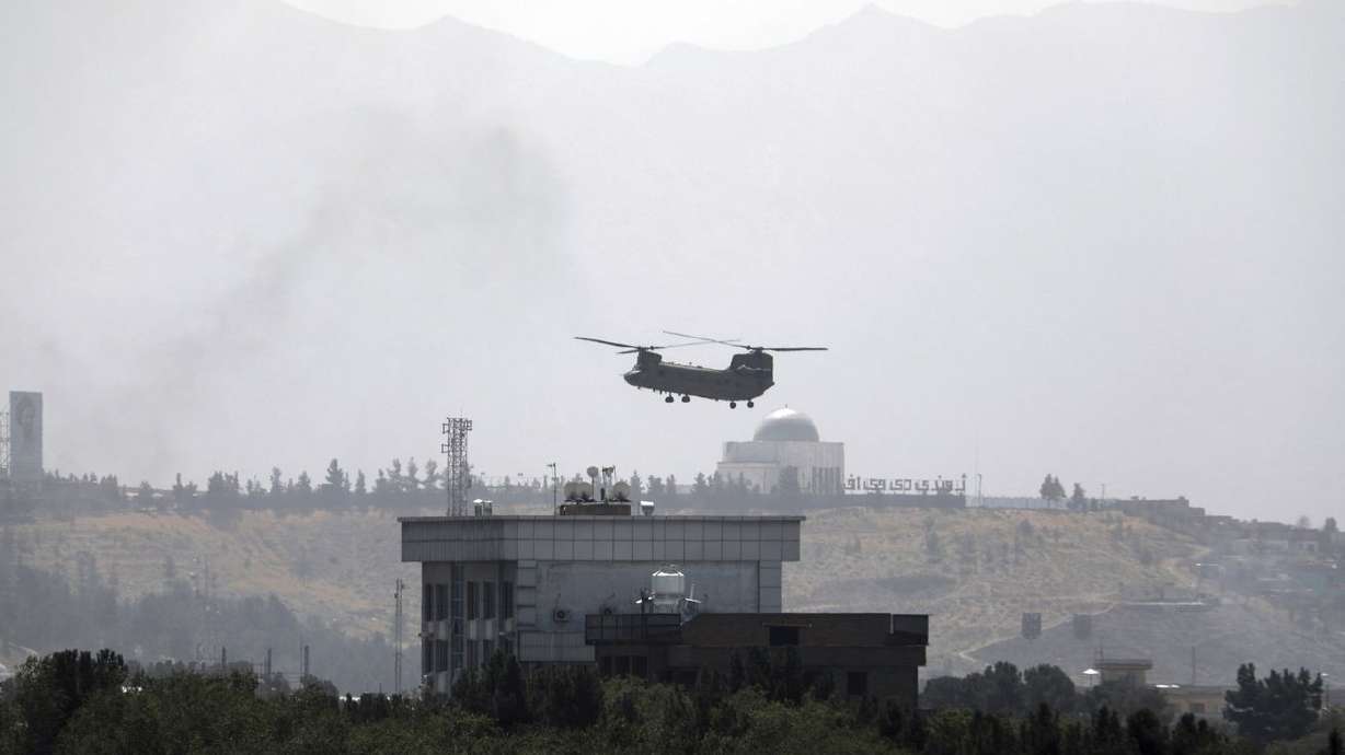 A U.S. Chinook helicopter flies over the U.S. Embassy
in Kabul, Afghanistan, on Aug. 15. Sen. Mitt Romney,
R-Utah, one of the sharpest critics of the American troop
withdrawal from Afghanistan this past summer, says the episode left
the United States "showered with shame.”