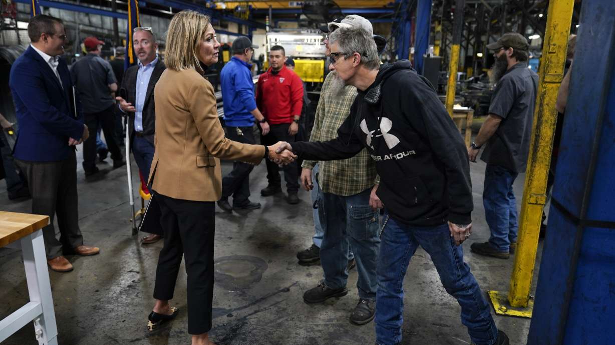 Iowa Gov. Kim Reynolds greets employees at Iowa Spring Manufacturing Oct. 20, in Adel, Iowa. The number of Americans applying for unemployment benefits fell for the seventh straight week Thursday to 268,000.
