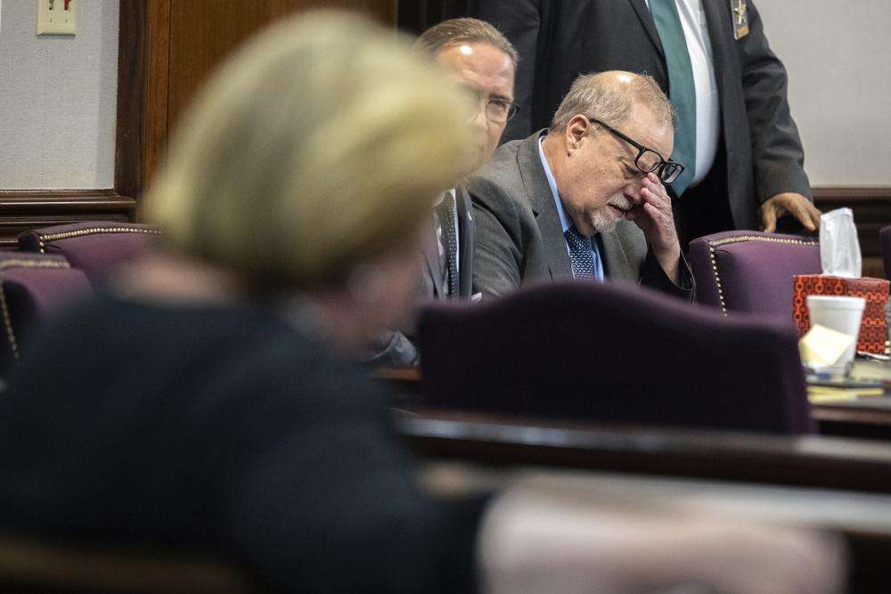Greg McMichael wipes his eyes during a recess in the testimony of his son Travis McMichael during their trial and trial of their neighbor William "Roddie" Bryan at the Glynn County Courthouse, Wednesday, in Brunswick, Ga. The three are charged with the February 2020 slaying of 25-year-old Ahmaud Arbery.