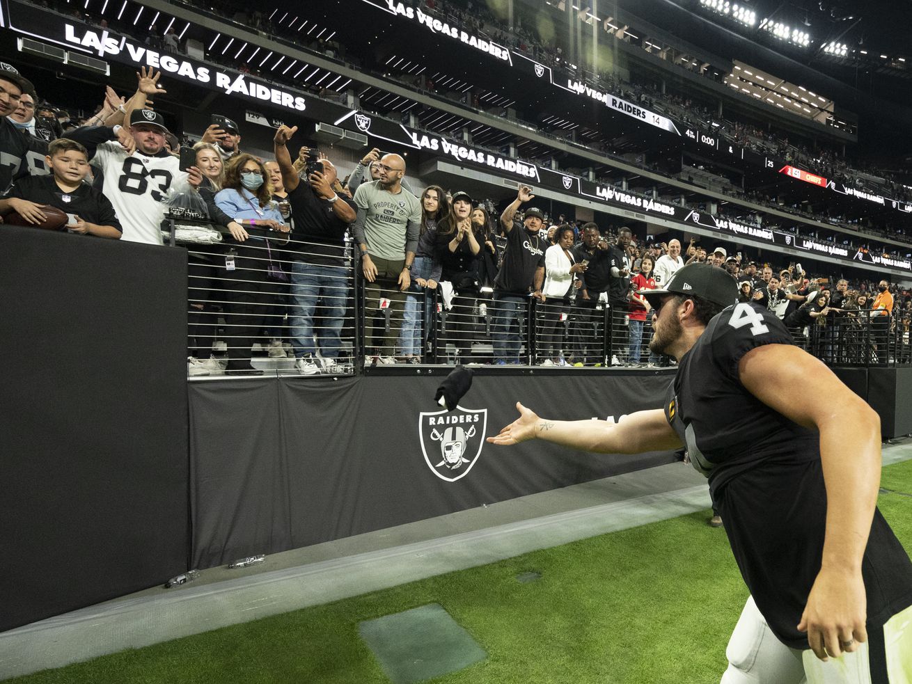 Las Vegas Raiders quarterback Derek Carr (4) tosses a souvenir to a fan after playing the Kansas City Chiefs during an NFL game on Sunday in Las Vegas. As media reports of possible NFL expansion swirl, Utah would be "all over” an opportunity to bring a professional football team to the state, Gov. Spencer Cox said Thursday.