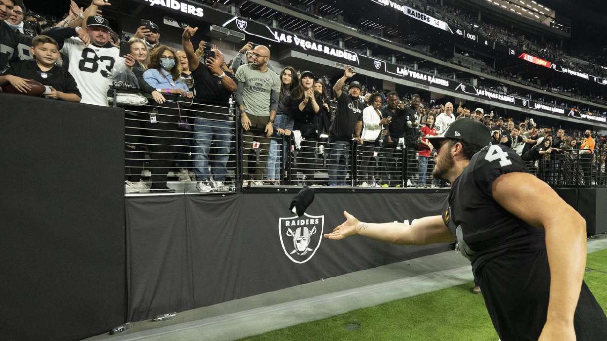 Las Vegas Raiders quarterback Derek Carr (4) tosses a souvenir to a fan after playing the Kansas City Chiefs during an NFL game on Sunday in Las Vegas. As media reports of possible NFL expansion swirl, Utah would be "all over” an opportunity to bring a professional football team to the state, Gov. Spencer Cox said Thursday.