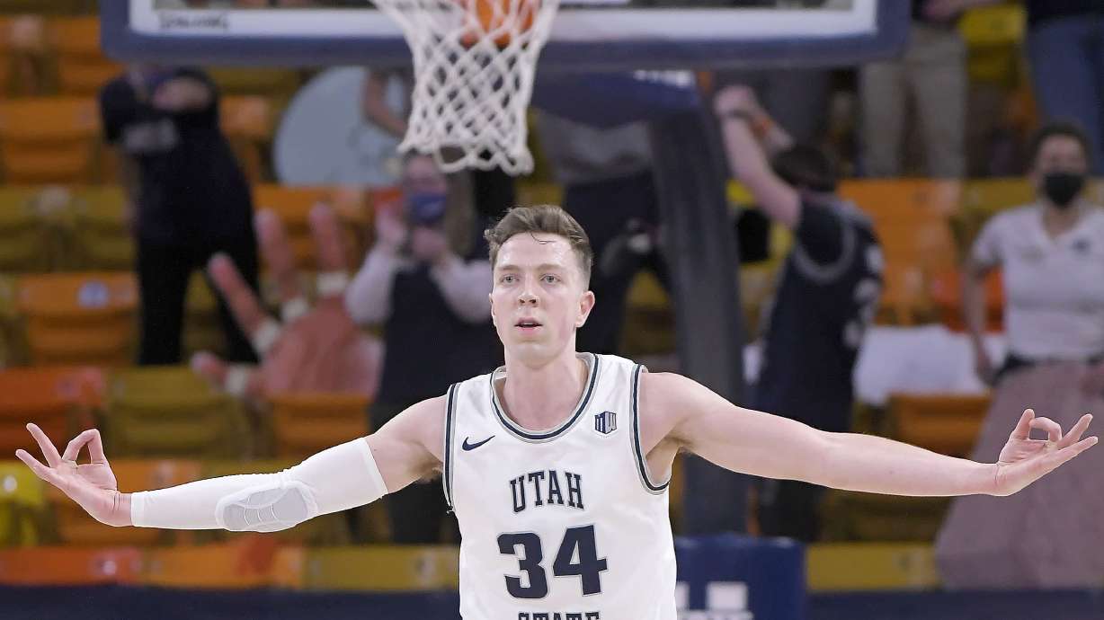 Utah State forward Justin Bean (34) celebrates after making a three-point basket during the second half of an NCAA college basketball game against Nevada, Friday, Feb. 26, 2021, in Logan, Utah.