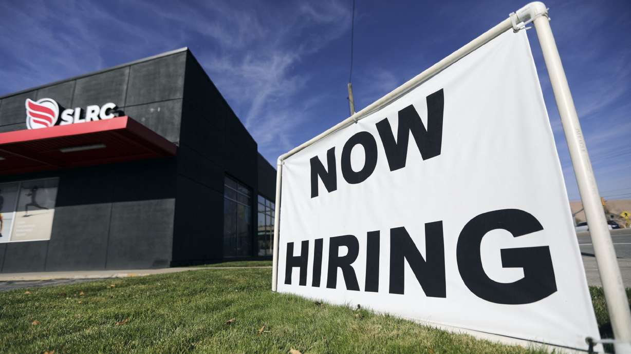 A “now hiring” sign is pictured at Salt Lake Running Company in Salt Lake City on Nov. 5. Utah reported its lowest unemployment rate ever Friday morning.