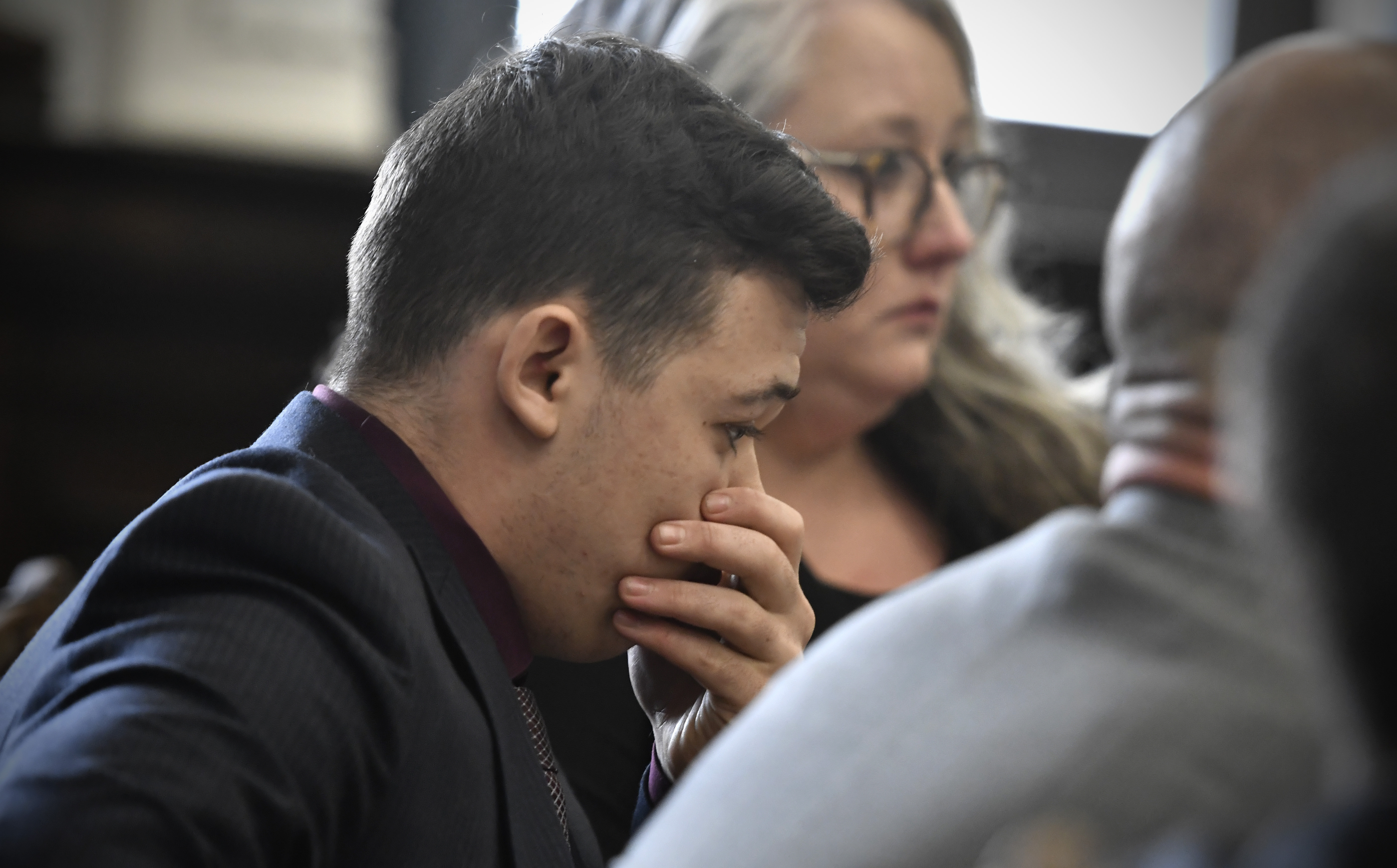 Kyle Rittenhouse puts his hand over his face after he is found not guilty on all counts at the Kenosha County Courthouse in Kenosha, Wis., on Friday. The jury came back with its verdict after close to 3 1/2 days of deliberation.