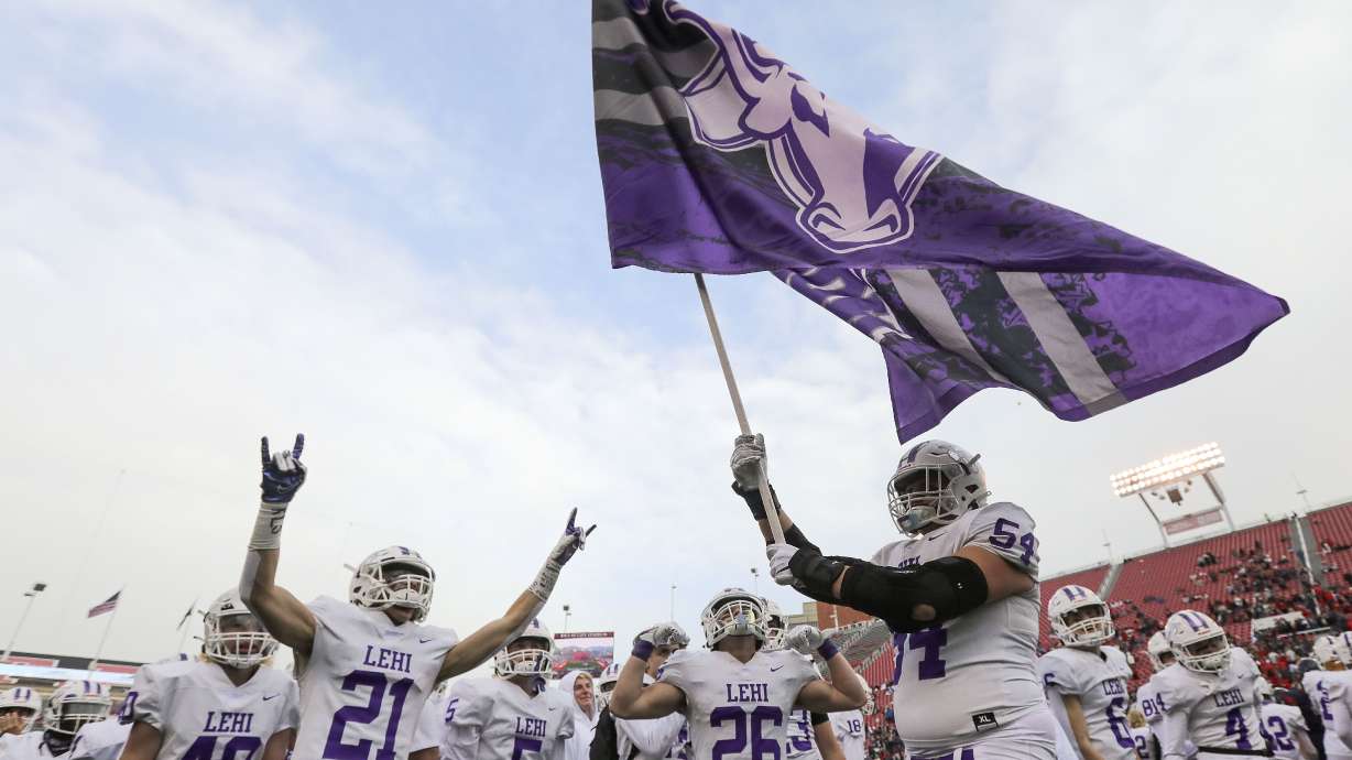 Lehi High School players celebrate winning the 5A football championship game against Springville High School at Rice-Eccles Stadium in Salt Lake City on Friday, Nov. 19, 2021. Lehi won 35-6.