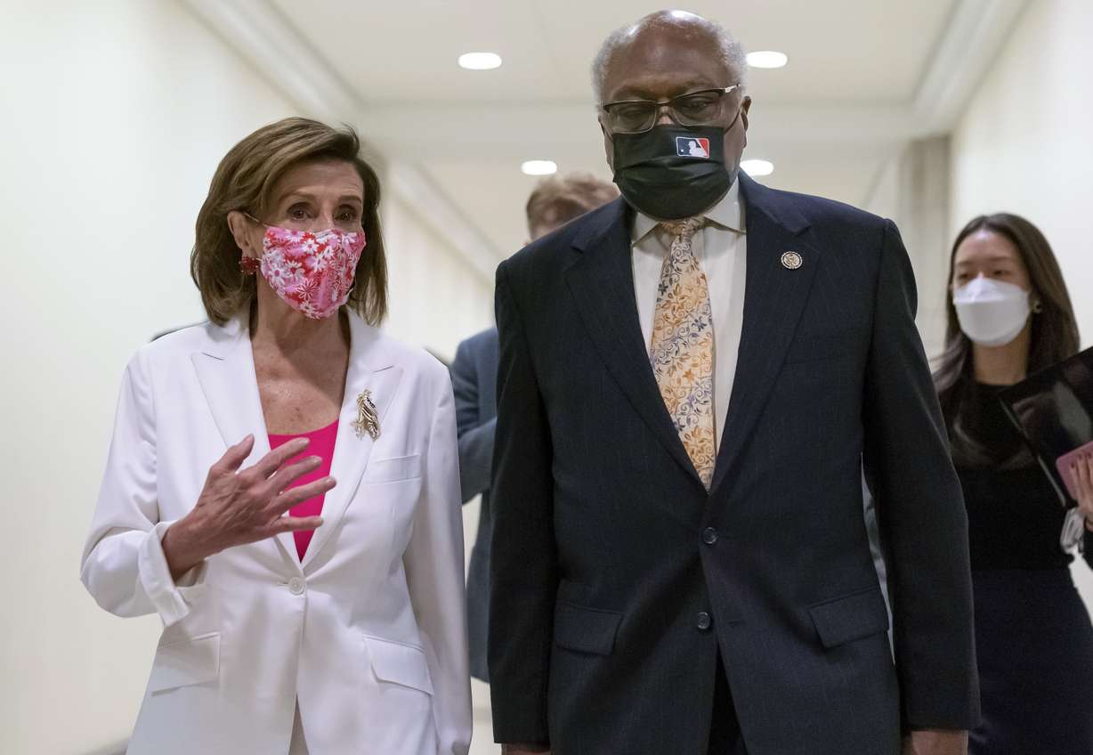 Speaker of the House Nancy Pelosi, D-Calif., walks with House Majority Whip James Clyburn, D-S.C., right, to meet with reporters after the House approved the Democrats' social and environment bill, giving a victory to President Joe Biden, at the Capitol in Washington, Friday, Nov. 19, 2021.