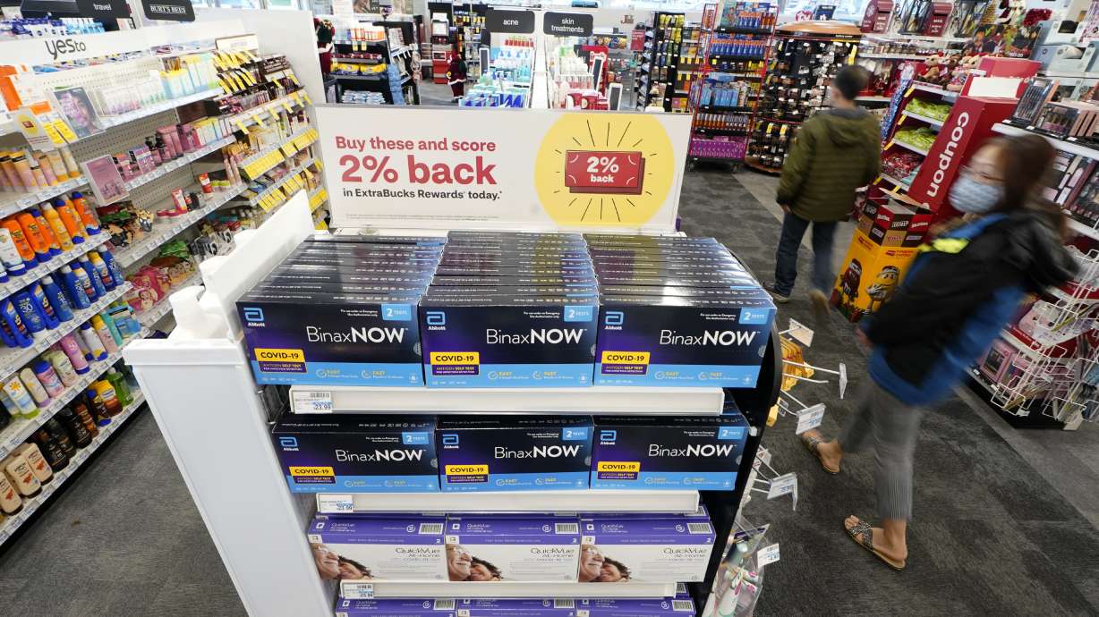 Boxes of BinaxNow home COVID-19 tests made by Abbott and QuickVue home tests made by Quidel are shown for sale Monday at a CVS store in Lakewood, Wash. After weeks of shortages, retailers like CVS say they now have ample supplies of rapid COVID-19 test kits, but experts are bracing to see whether it will be enough as new outbreaks spark across the country.