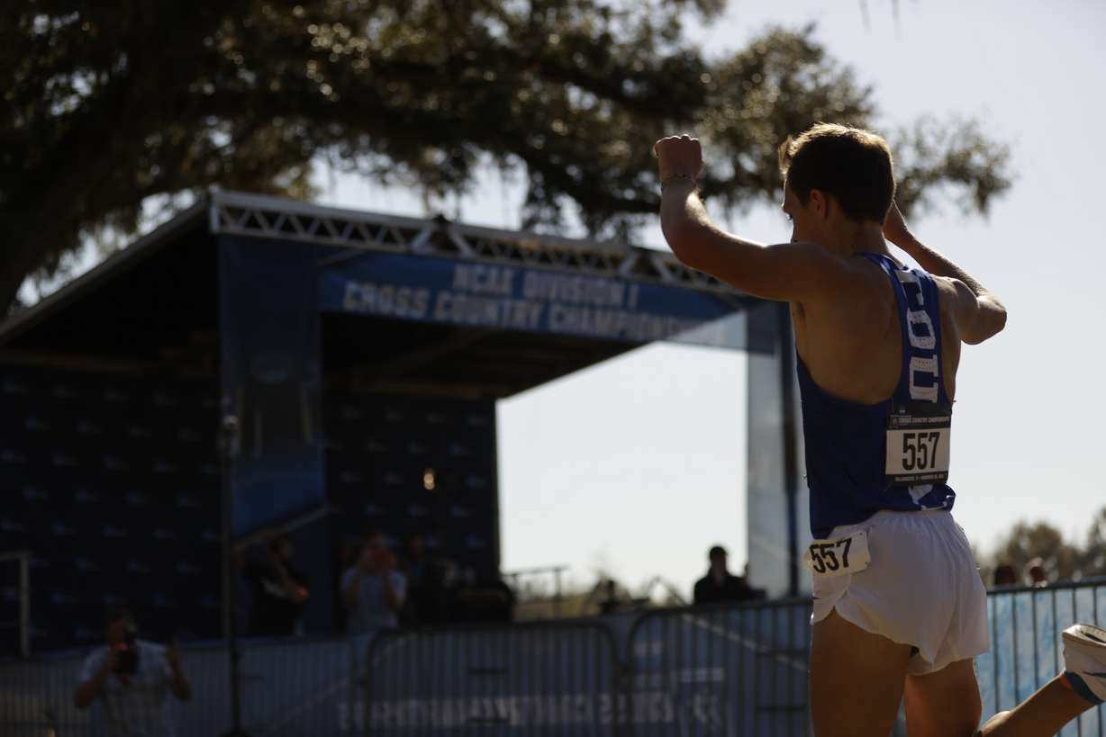 BYU's Conner Mantz raises his arms as he crosses the finish line first at the NCAA national championships, Saturday, Nov. 20, 2021 in Tallahassee, Florida.