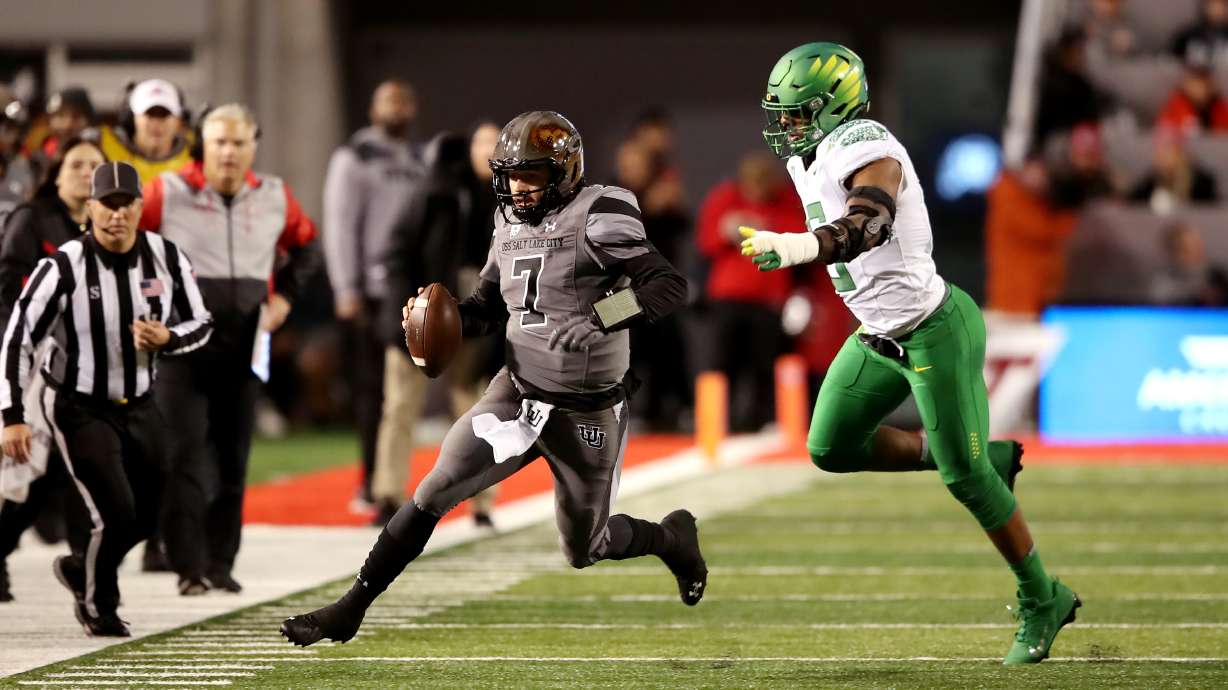 Utah Utes quarterback Cameron Rising (7) runs out of bounds with Oregon Ducks defensive end Kayvon Thibodeaux (5) defending on the play as Utah and Oregon play an NCAA football game at Rice Eccles Stadium in Salt Lake City on Saturday, Nov. 20, 2021.