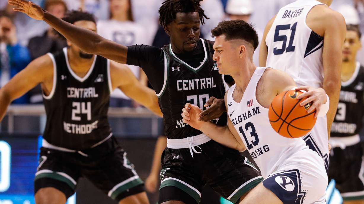 BYU guard Alex Barcello (13) dribbles past Central Methodists’ Jonathan Brown during an NCAA game at the Marriott Center in Provo on Saturday, Nov. 20, 2021.