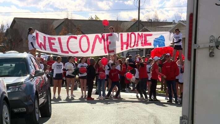 Friends, family and community members welcome the McDonald family back to their newly renovated home in Taylorsville on Saturday.