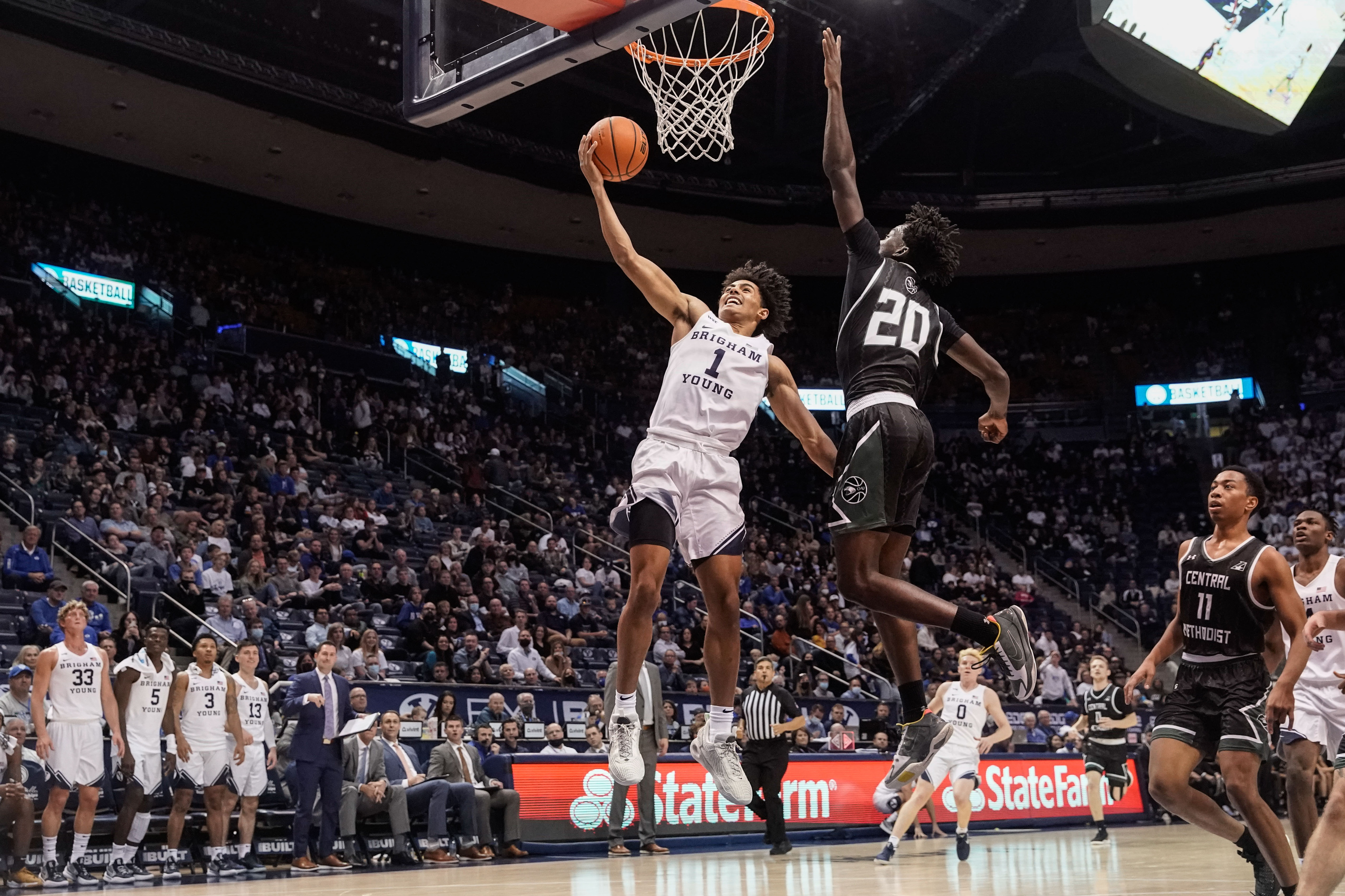BYU guard Trey Stewart (1) goes for a shot as Central Methodist guard Jonathan Brown (20) reaches to intercept during an NCAA game at the Marriott Center in Provo on Saturday, Nov. 20, 2021.