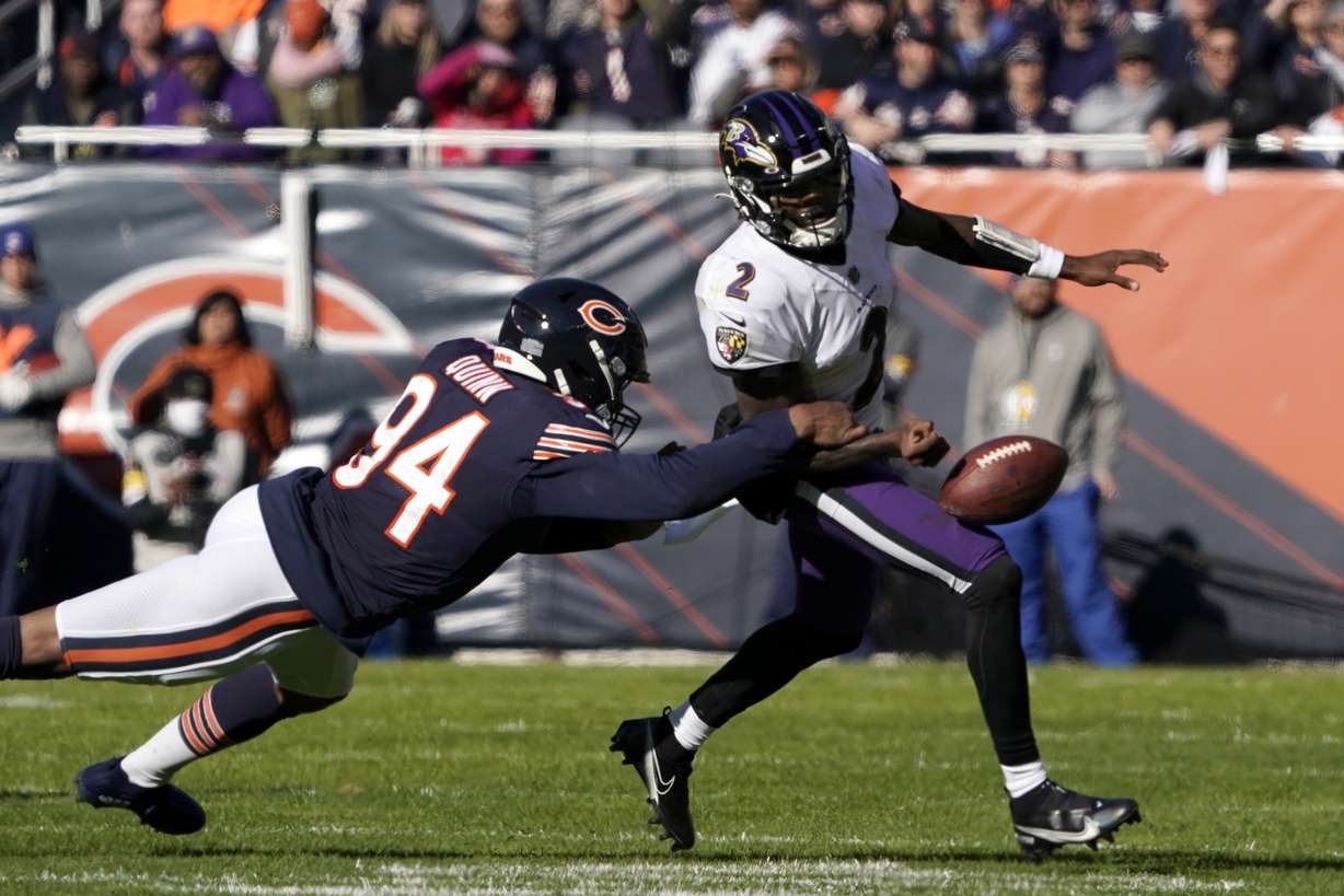 Chicago Bears outside linebacker Robert Quinn (94) strips the ball from Baltimore Ravens quarterback Tyler Huntley during the first half of an NFL football game Sunday, Nov. 21, 2021, in Chicago.