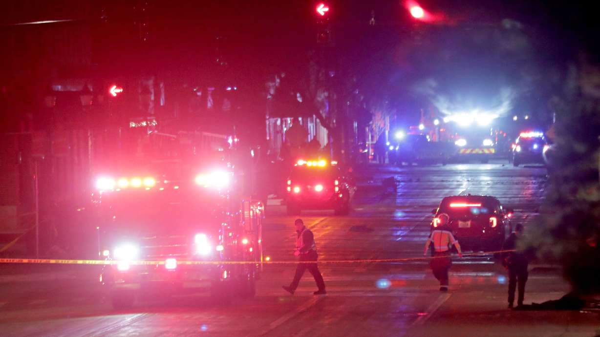 Police investigate at the scene of a crash involving multiple people and injuries at a holiday parade in Waukesha, Wis., on Sunday.