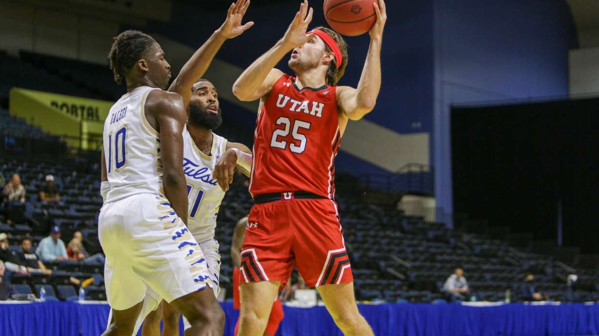 Utah's Rollie Worster (25) prepares to go up for a shot against two Tulsa defenders during the Sunshine Slam tournament in Daytona Beach, Fla. on Nov. 21, 2021.