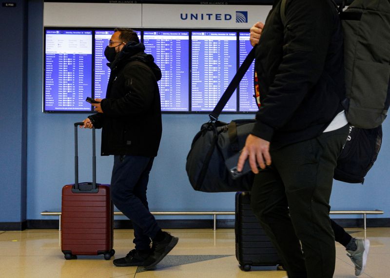 Travelers walk through O'Hare International Airport in Chicago, Ill., Saturday. Airlines and airports braced Monday for a surge of travelers ahead of the Thanksgiving holiday.