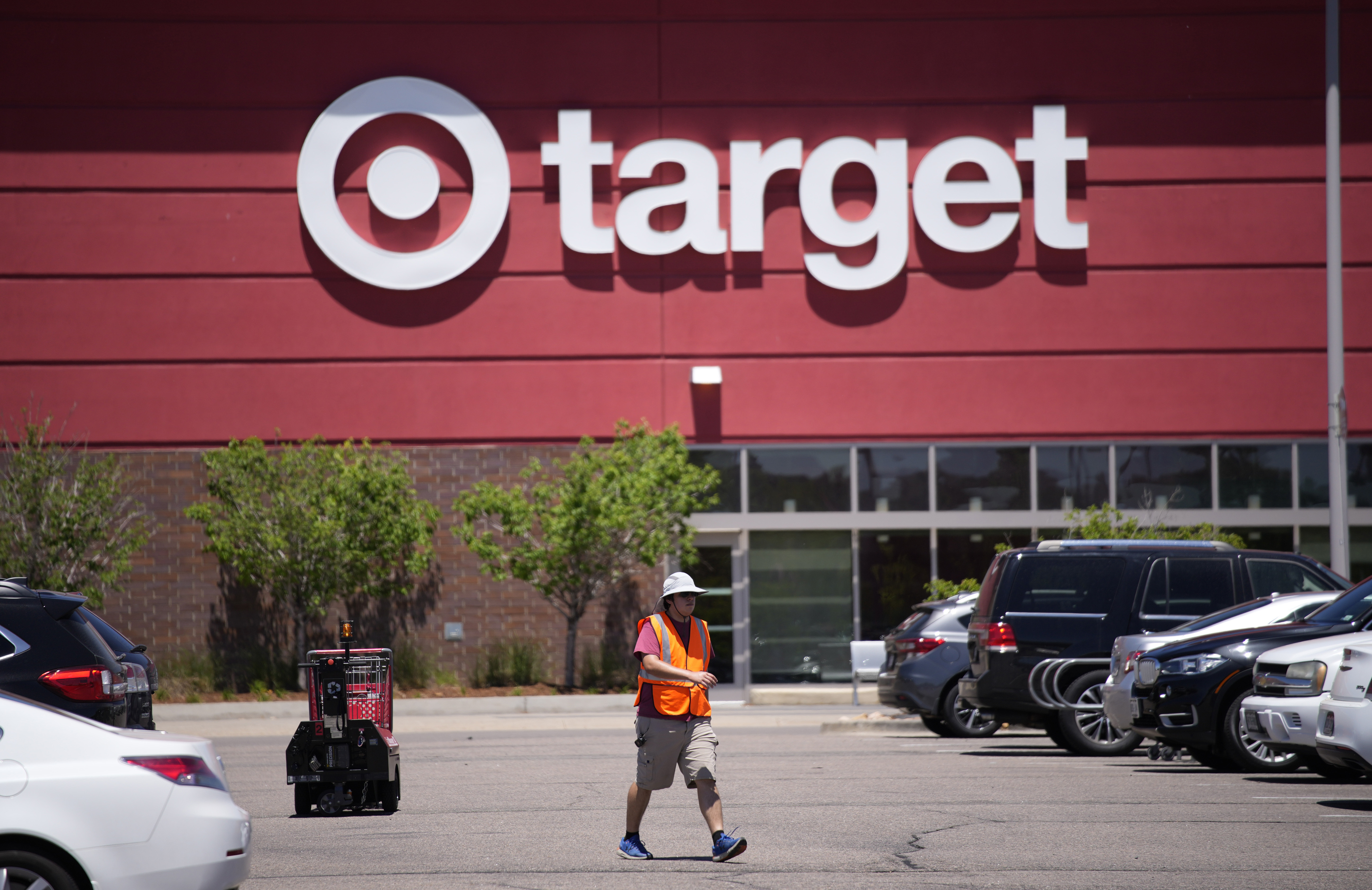 A worker collects shopping carts in the parking lot of a Target store on June 9, in Highlands Ranch, Colo. Target will no longer open its stores on Thanksgiving Day, the company announced Monday.