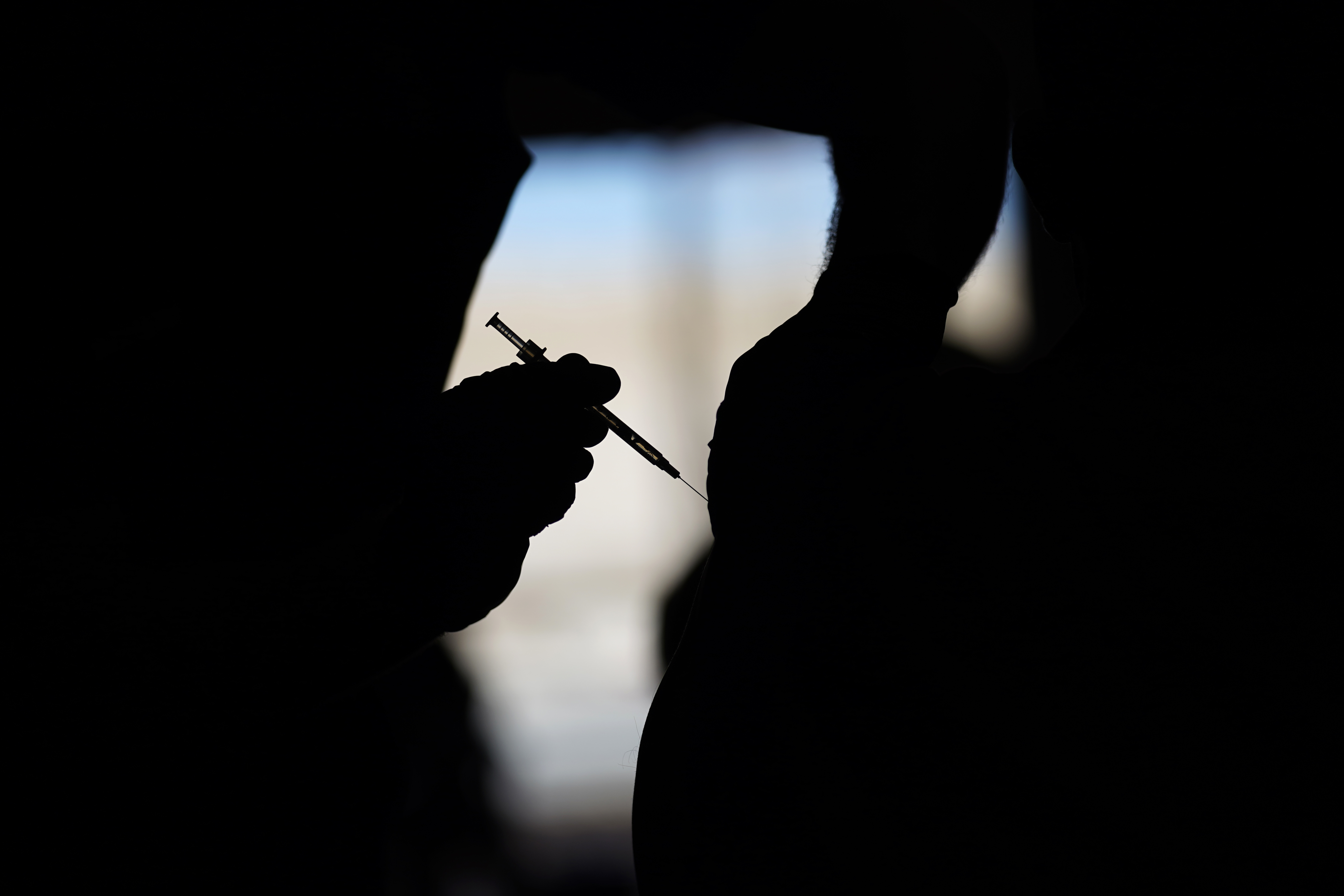 A man receives a COVID-19 vaccine in Las Vegas. More than 90% of federal workers received at least one dose of a COVID-19 vaccine by Monday's deadline set by President Biden.