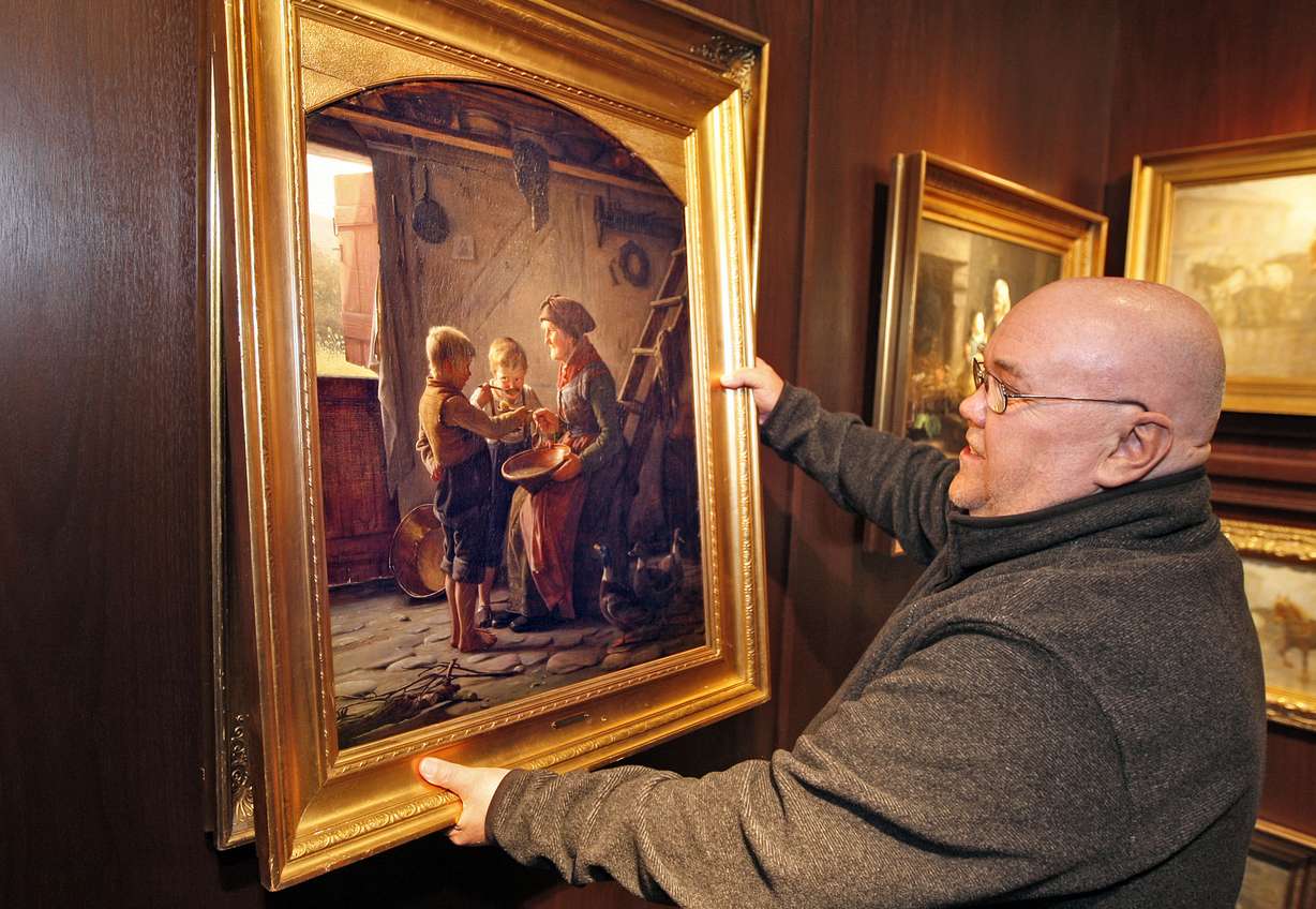 Soren Edsbery admires "Mealtime at Grandma's" as 17 original oil paintings by famed artist Carl Bloch are returned by museums in Denmark to the Hope Gallery in Salt Lake after a hugely successful exhibition of his works there Thursday, Feb. 28, 2013, in Salt Lake City.