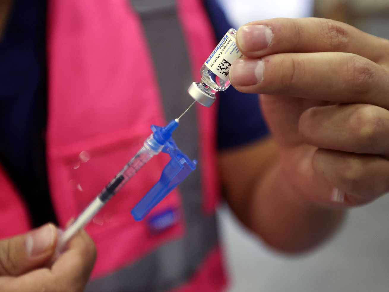 Davis County community health nurse Bruno Gonzalez gets
a vial of the Johnson & Johnson COVID-19 vaccine Oct. 25. Utahns shouldn't put off getting a booster shot because of the omicron variant, an Intermountain Healthcare infectious diseases physician said Tuesday.