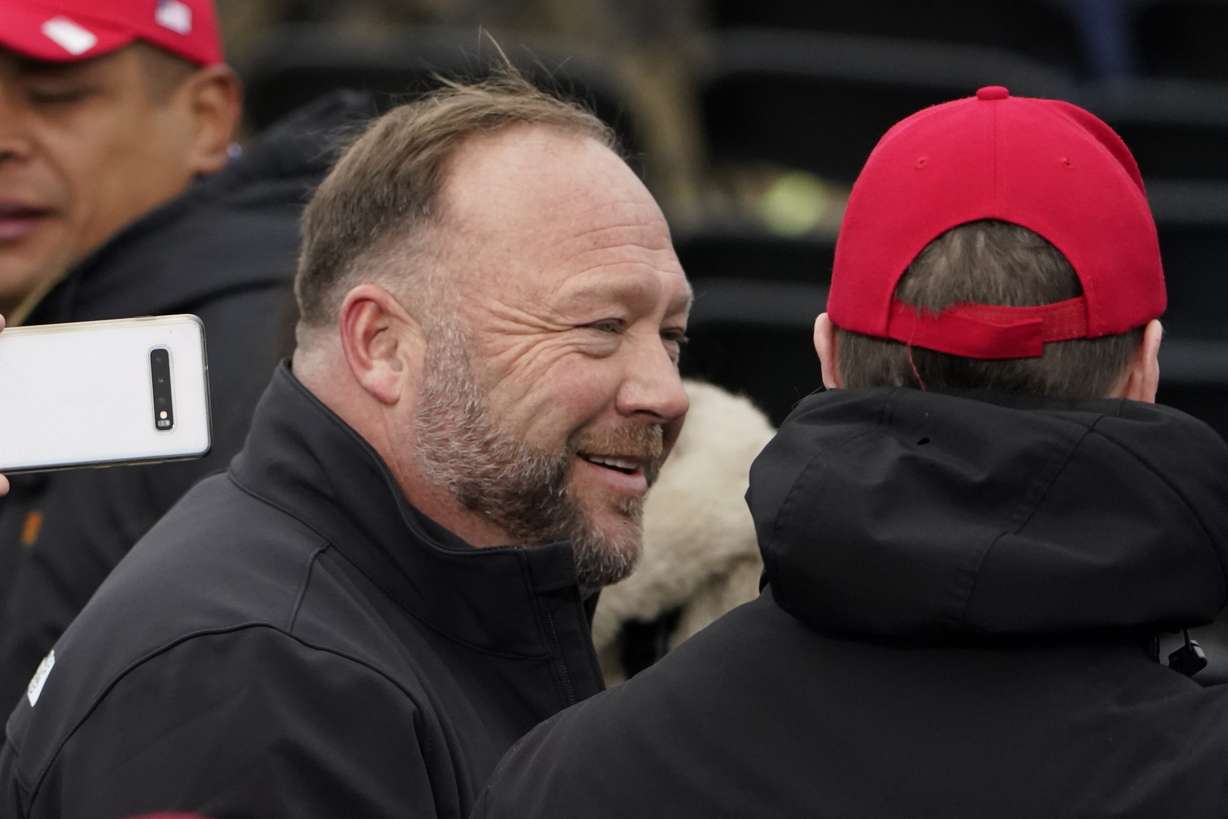 Alex Jones, left, attends a rally in support of President Donald Trump called the "Save America Rally," on Jan. 6, 2021, in Washington.