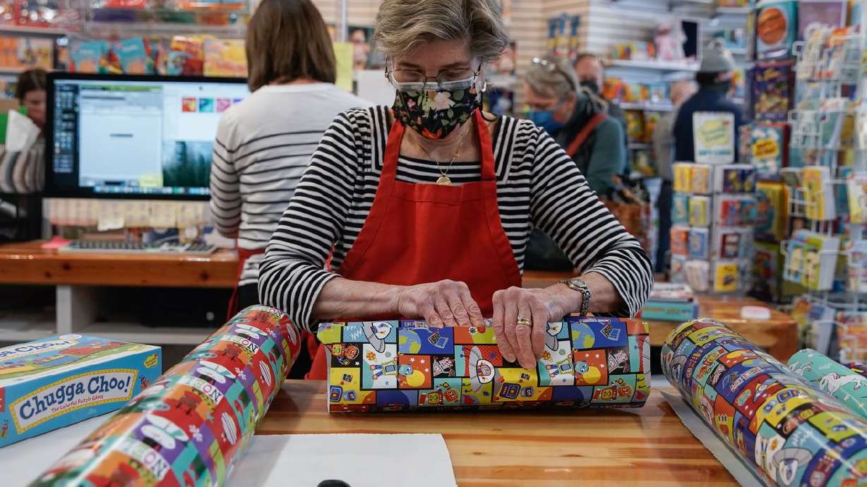 Diane Sartain, owner of Tutoring Toy in Salt Lake City,
helps customers on Monday.