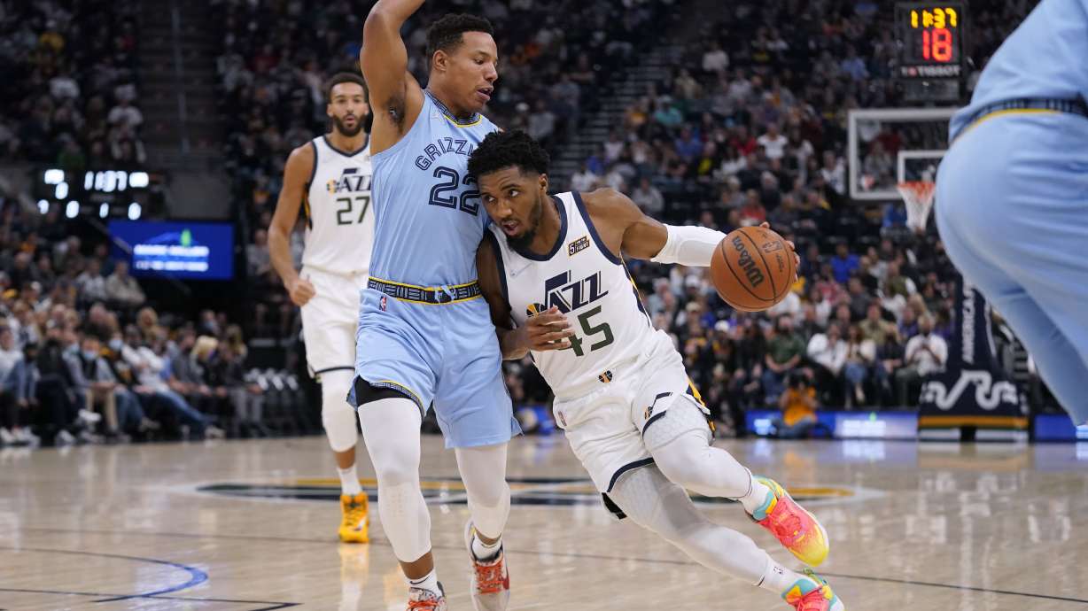 Utah Jazz guard Donovan Mitchell (45) drives around Memphis Grizzlies guard Desmond Bane (22) during the first half of an NBA basketball game Monday, Nov. 22, 2021, in Salt Lake City.