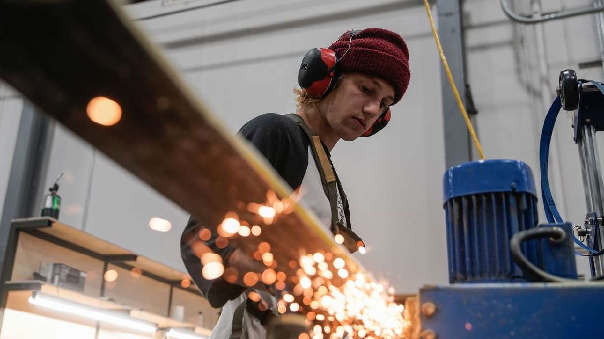 Zach Sinclair finishes polishing a ski at WNDR Alpine, a local company that uses algae-based bioplastics to replace
plastics used in ski construction, at the company’s facility in Salt Lake City, Friday.