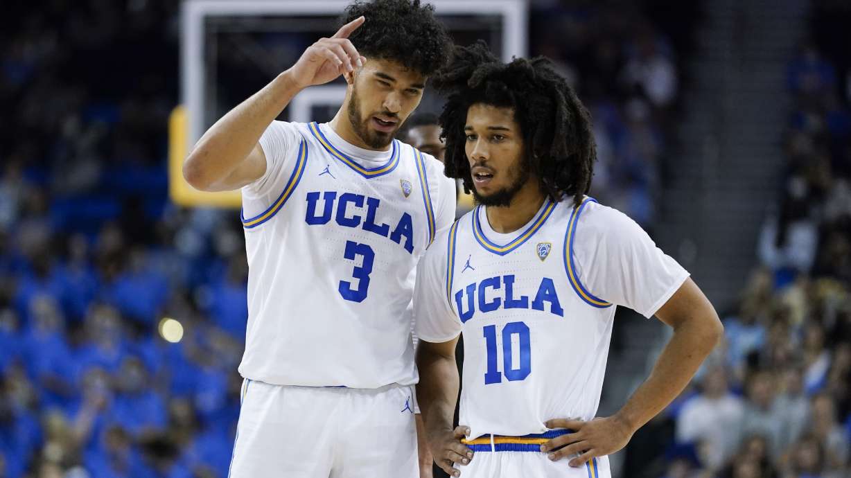 UCLA guard Johnny Juzang (3) and guard Tyger Campbell (10) talk during the first half of an NCAA college basketball game against the Long Beach State in Los Angeles, Monday, Nov. 15, 2021.