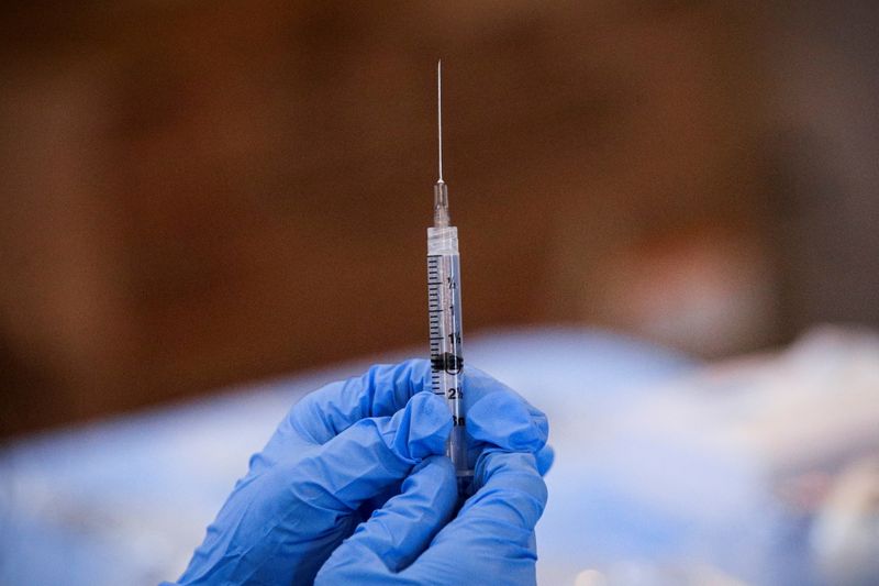 A syringe is filled with a dose of Pfizer's COVID-19 vaccine at a pop-up community vaccination center at the Gateway World Christian Center in Valley Stream, New York, on Feb. 23.