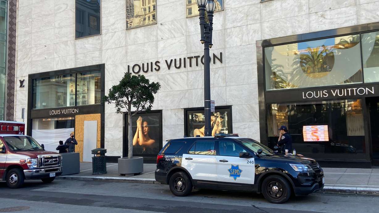 Police officers and emergency crews park outside the Louis Vuitton store in San Francisco's Union Square on Sunday, after looters ransacked businesses.