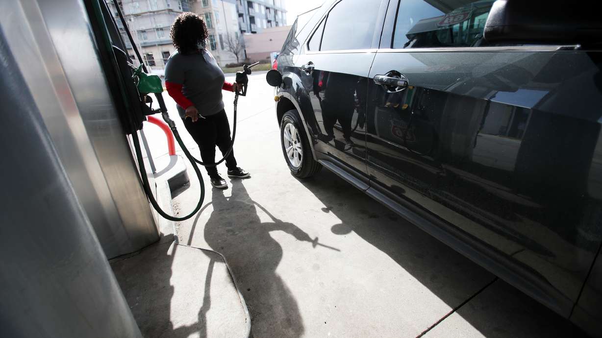 Rosiland Edwards prepares to pump gasoline at Harts Gas & Food in Midvale on March 24. Utah's average gas prices are up 60% from the same time last year, according to AAA.