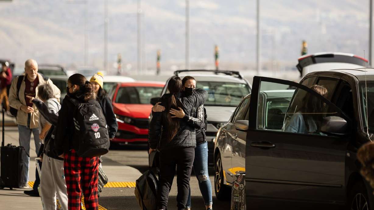 Patricia Palafox and Trina Pond, right, embrace at Salt
Lake International Airport in Salt Lake City on Nov. 18.