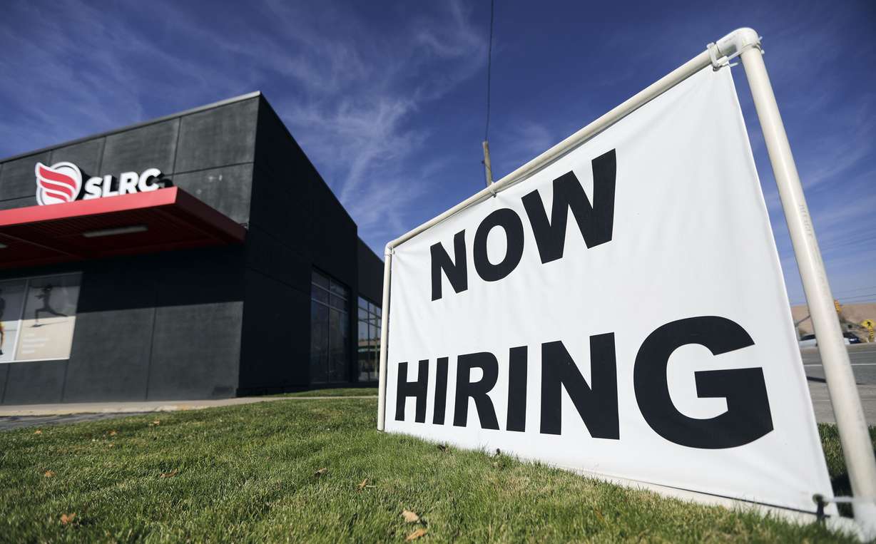 A “now hiring” sign is pictured at Salt Lake Running Company in Salt Lake City on Nov. 5.