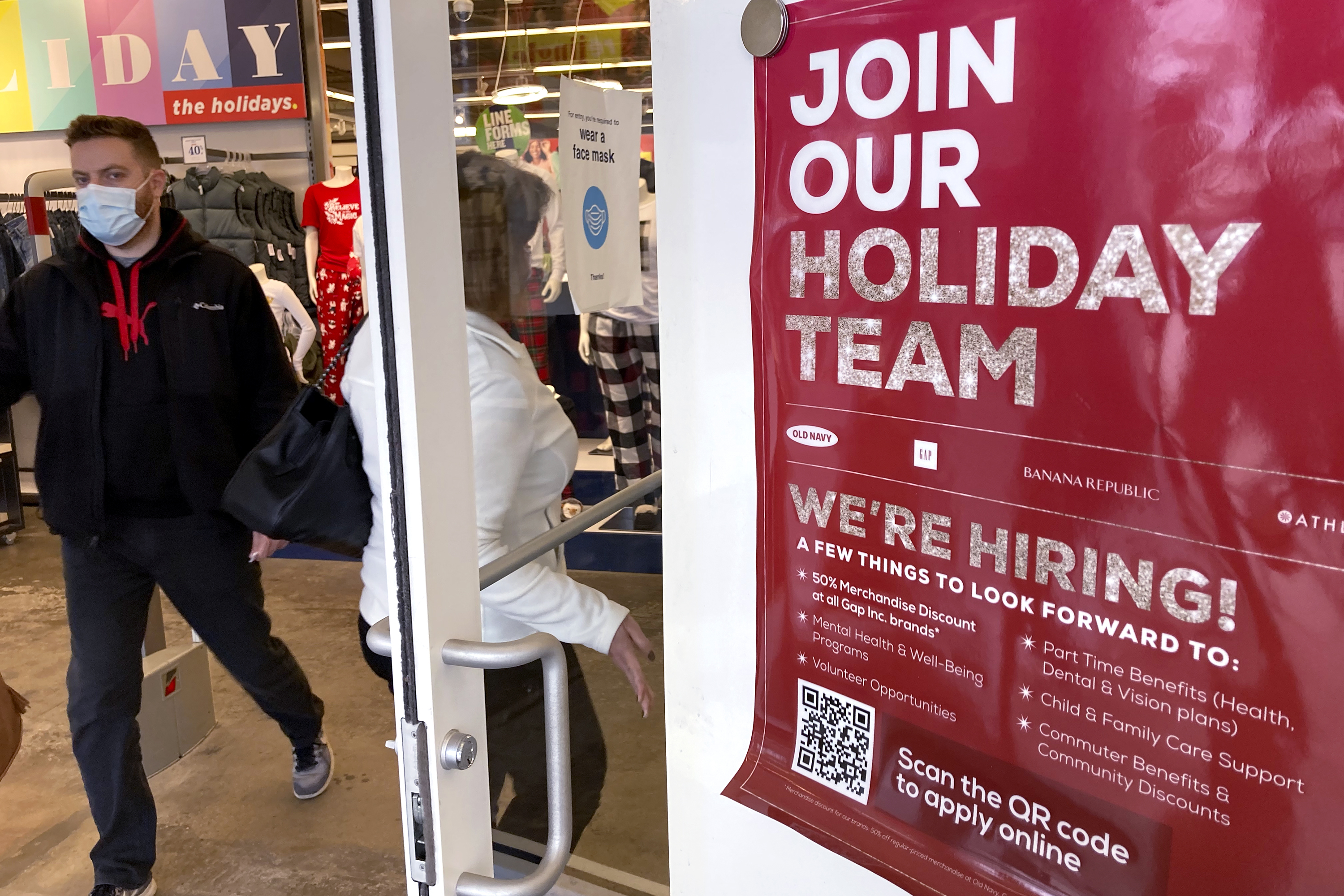 Holiday hiring sign is displayed at a retail store in Vernon Hills, Ill., Nov. 13. The number of Americans applying for unemployment benefits plummeted last week to the lowest level in more than half a century.