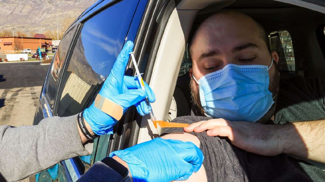 Tanner Davies receives a COVID-19 vaccination at a NOMI/TestUtah vaccination site in Lindon on Nov. 23. Utah health officials confirmed 1,195 new cases and 20 additional deaths on Tuesday.