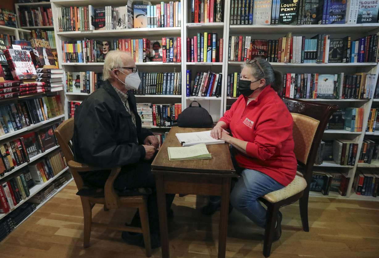 Local author Tim Larson, left, shows a manuscript to Anne Holman, co-owner of The King’s English Bookshop, for potential publication through TKE Ink, at The King’s English Bookshop in Salt Lake City on Wednesday. Salt Lake City Mayor Erin Mendenhall announced the Shop Small Crawl to support Small Business Saturday, including the chance to win a $500 local shopping spree.