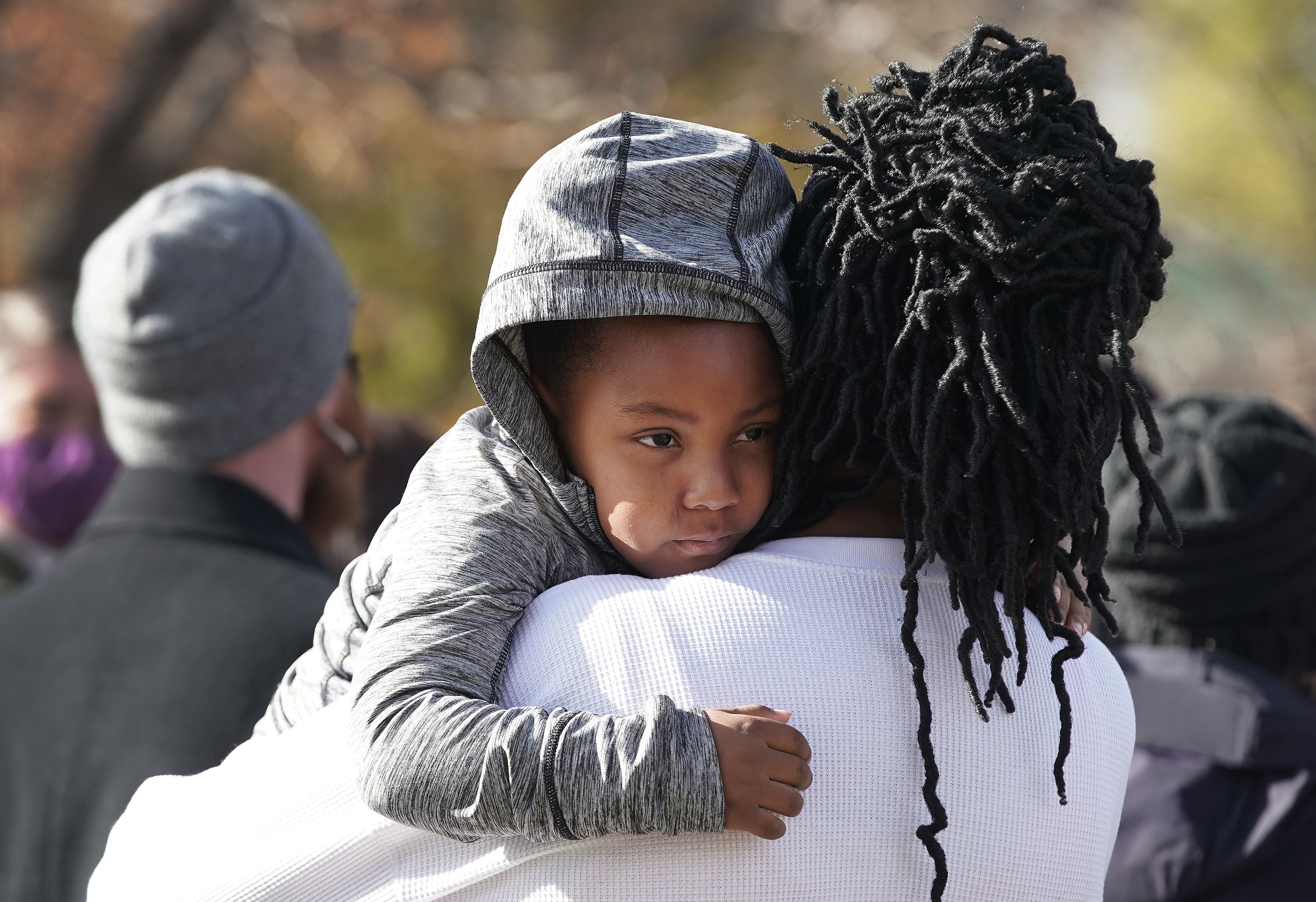Tristan Barnes, 3, hangs onto her mother during a press conference in Salt Lake City on Wednesday supporting the elimination of the sales tax on food. Thirteen states in the U.S. charge a sales tax on grocery purchases.