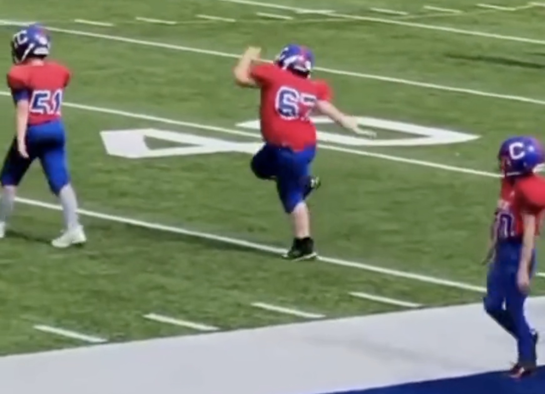 During warm-ups of his little league football game, this little guy is getting ready by having the time of his life and grooving out to the music over the speaker.
