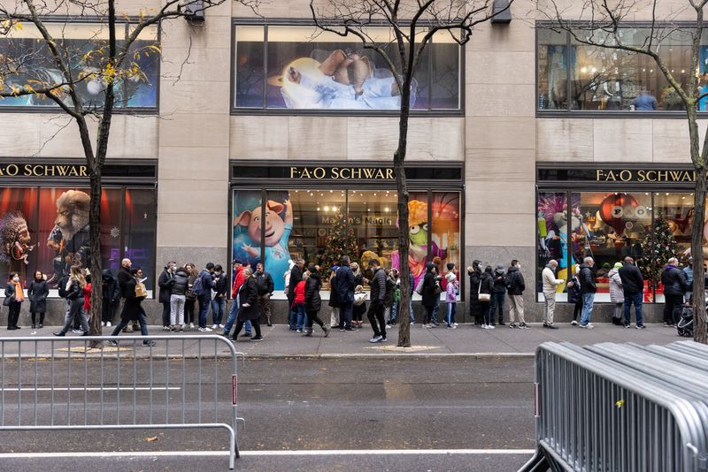 Shoppers wait in line to enter a the FAO Schwarz toy store during Black Friday sales in the Manhattan borough of New York City, New York, Friday.